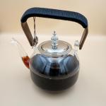 Elegant glass teapot with silver infuser and wooden handle